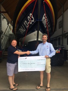 Exmouth pilot gig rowing club presenting cheque from open day